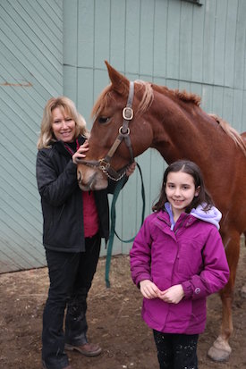 riding instructor Ann Walker with horse and girl on camp day