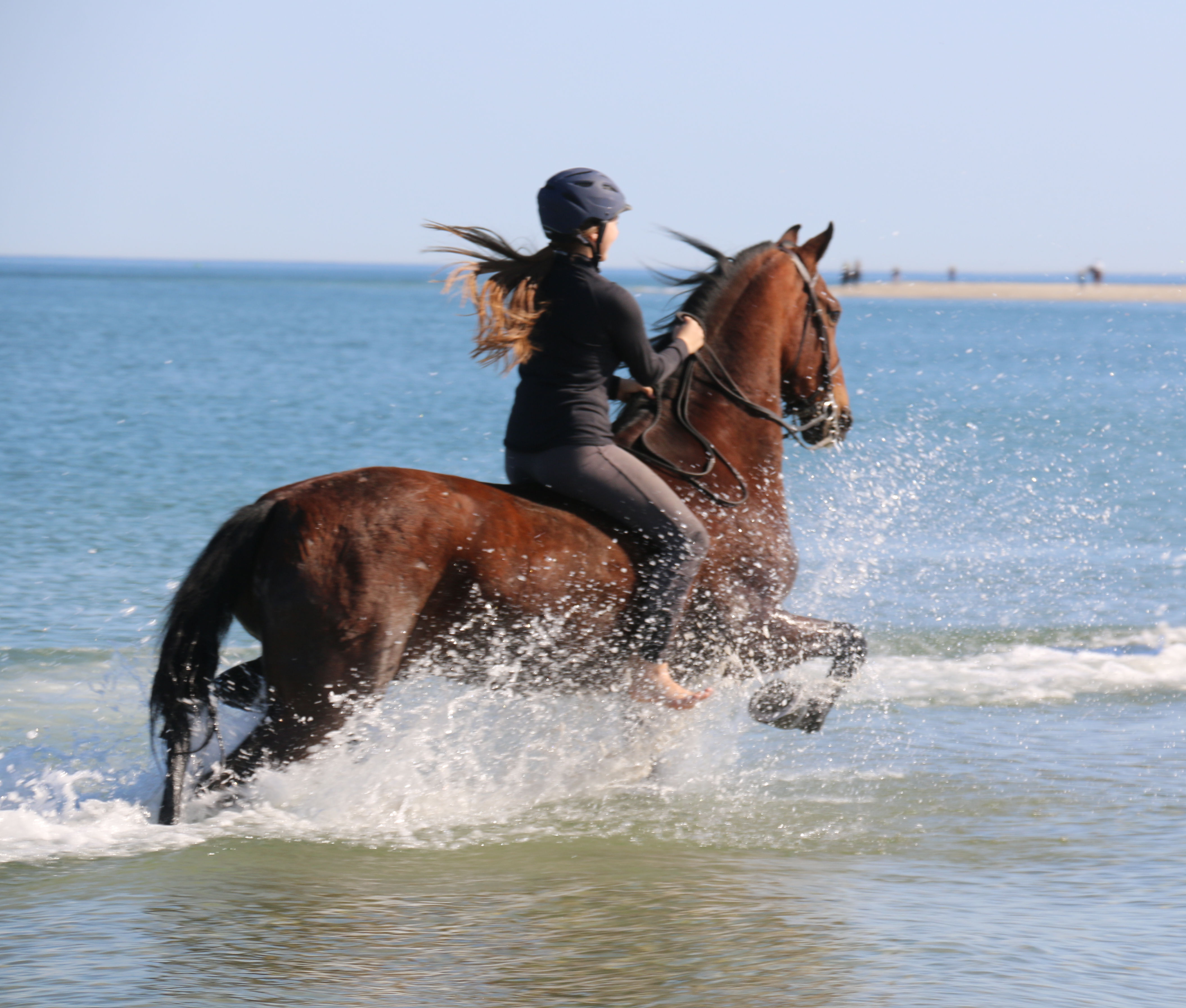 Rose and Mario enjoying riding through water at Crane beach